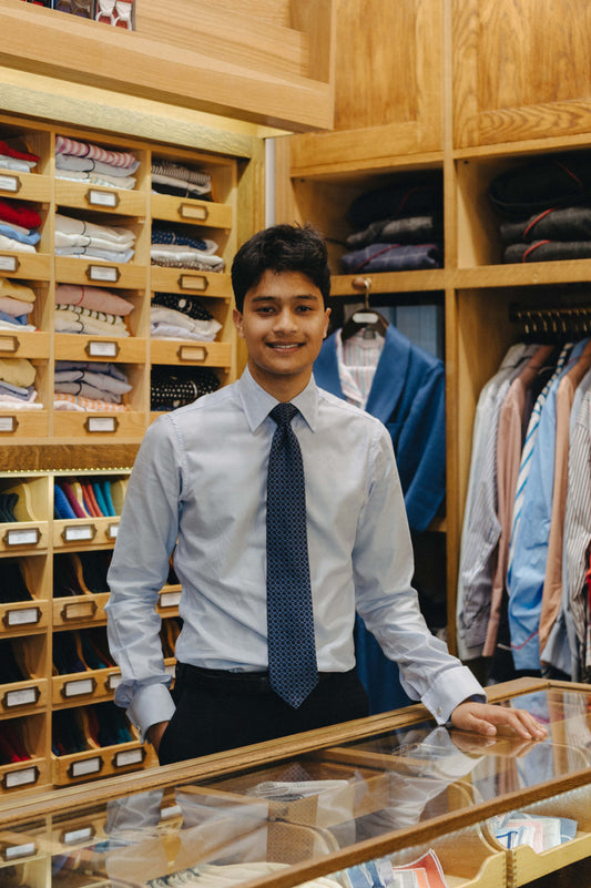 Sales consultant stood behind desk in Budd retail store