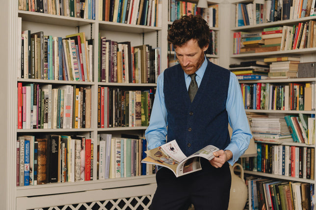 Man stood in library wearing smart business wear