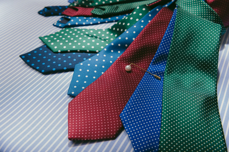 Selection of spotted ties on stripe blue background