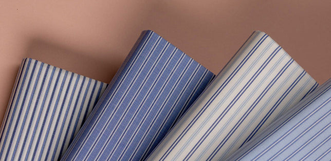 Sample of swatch shirt cloths laid out in various blue stripes