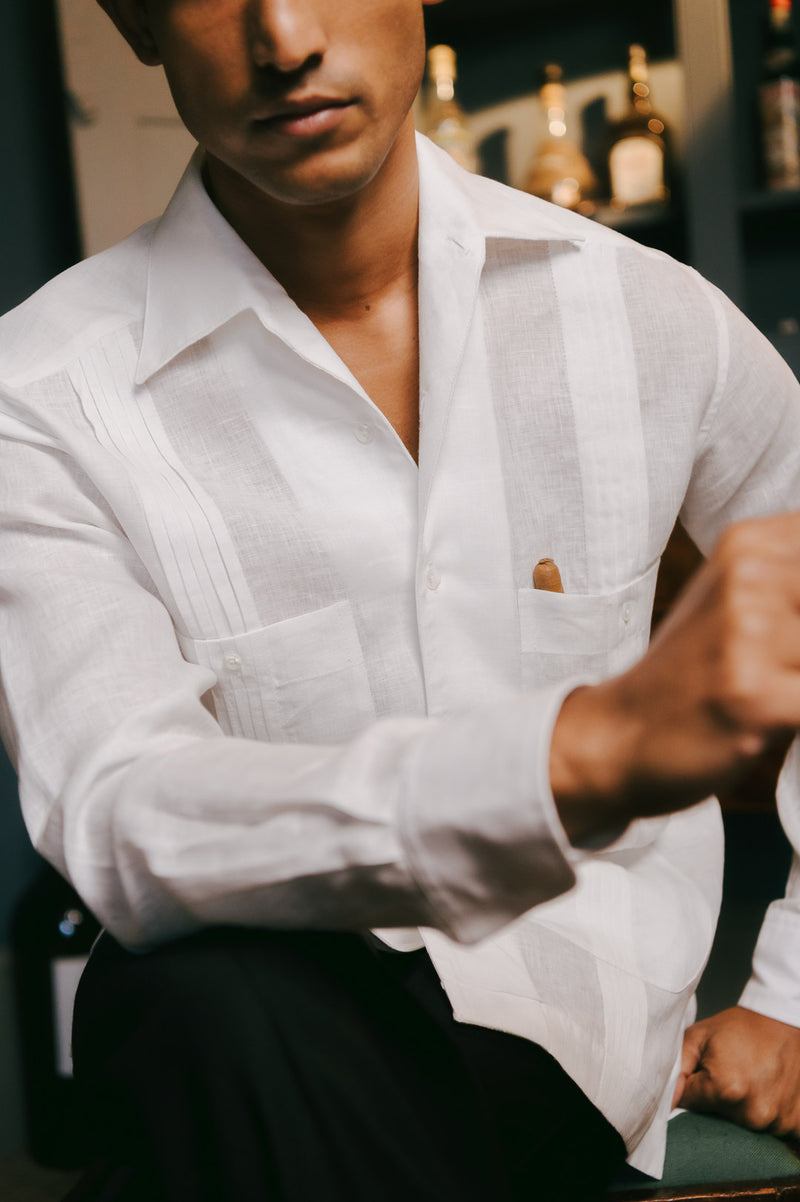 Person wearing a white shirt with a blurred background