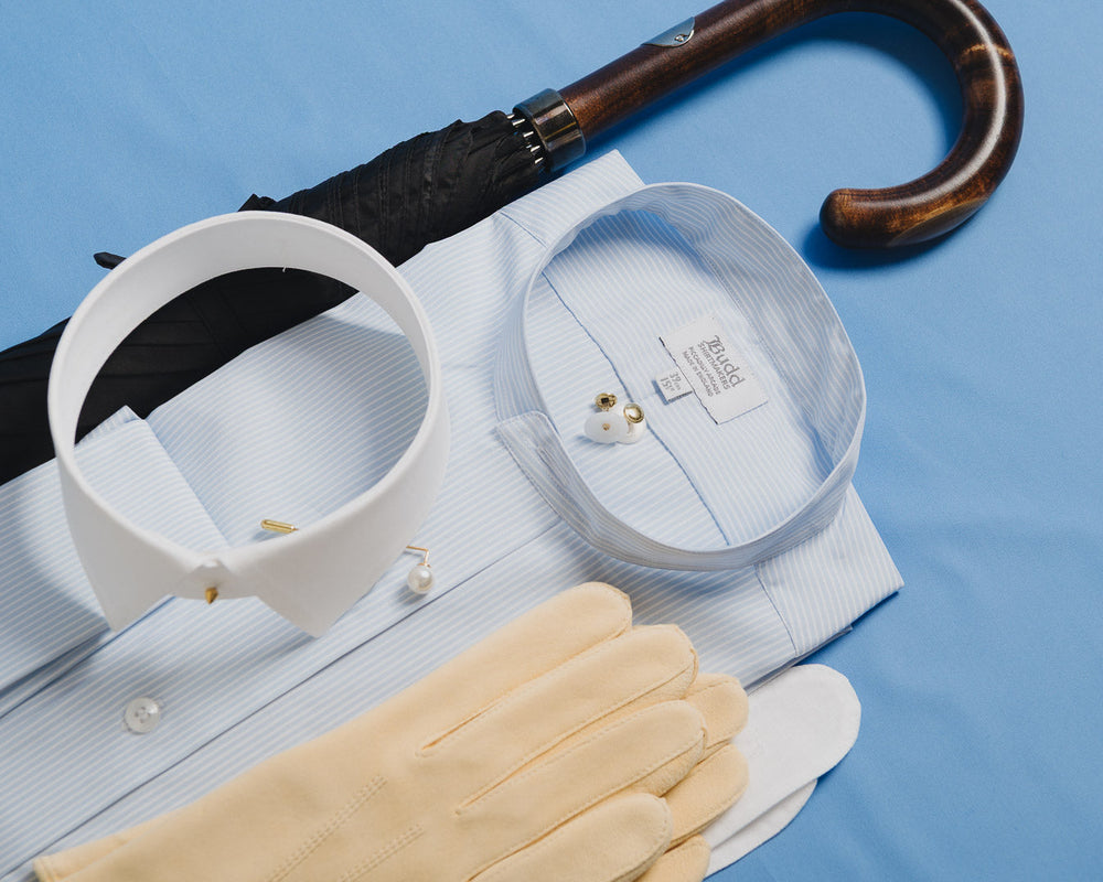 Collar, tie, and gloves on a blue background