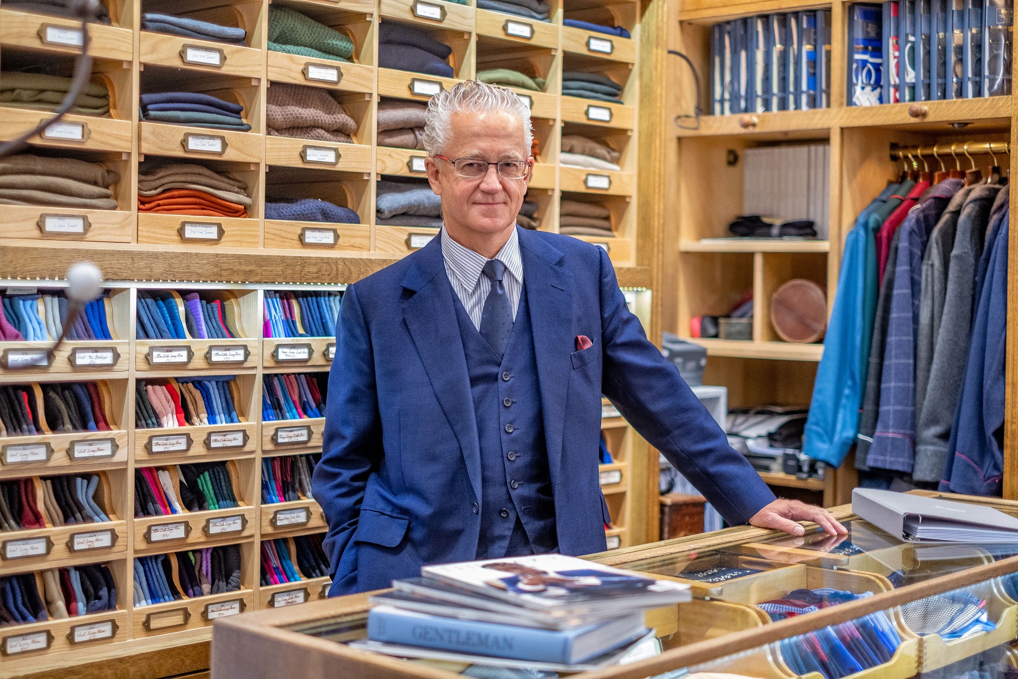 Store assistant stood behind counter in Budd Shirtmakers