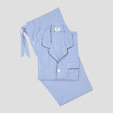 Blue and white striped pajama set with a long-sleeve button-up shirt and matching pants, laid flat on a light gray background.
