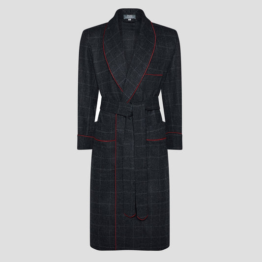 A dark charcoal gray plaid bathrobe with red piping trim, shown against a solid light gray background.