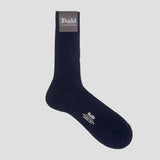 A single dark navy ribbed crew sock with white text branding on the toe and a dark brown cuff label reading 'Budd Shirtmakers', shown on a light gray background.