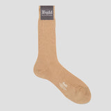 A single ribbed crew sock in a warm tan/beige color, shown against a light gray background. The sock features a dark brown brand label at the cuff with white text reading 'Budd Shirtmakers', and 'Budd' is also printed in white near the toe.