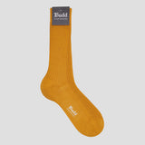 A single mustard yellow ribbed crew sock with a dark gray tag at the cuff and a white printed 'Budd' logo on the toe, shown against a solid light gray background.
