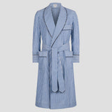 A blue and white vertically striped bathrobe with a shawl collar, waist tie belt, and front patch pockets, shown against a solid light gray background.