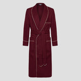 A long burgundy bathrobe with cream piping and a matching waist tie, shown flat against a light gray background.