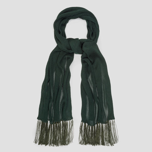 A dark forest green knit scarf with fringed ends, neatly arranged in a looped knot against a solid light gray background.