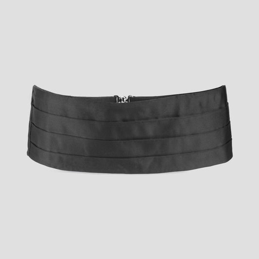 A wide black satin cummerbund with horizontal pleats and a small silver metal buckle at the center, displayed against a solid light gray background.