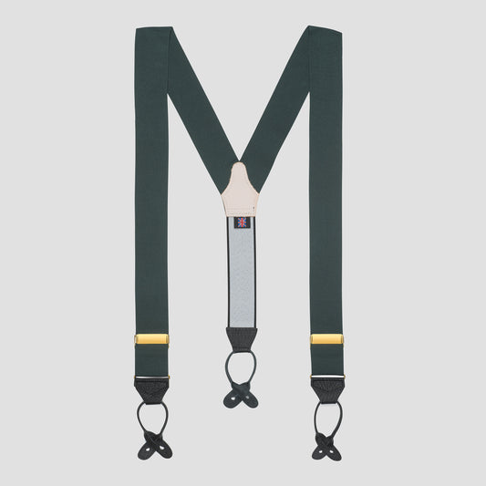 Dark green Y-back suspenders with black metal clips, gold metal accents, and a light gray central strap on a solid light gray background.