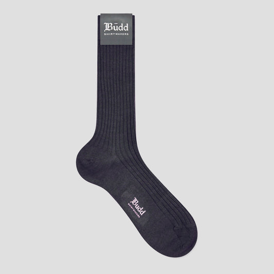 A single dark navy ribbed crew sock with 'Budd Shirtmakers' branding printed on the cuff and foot, displayed against a solid light gray background.