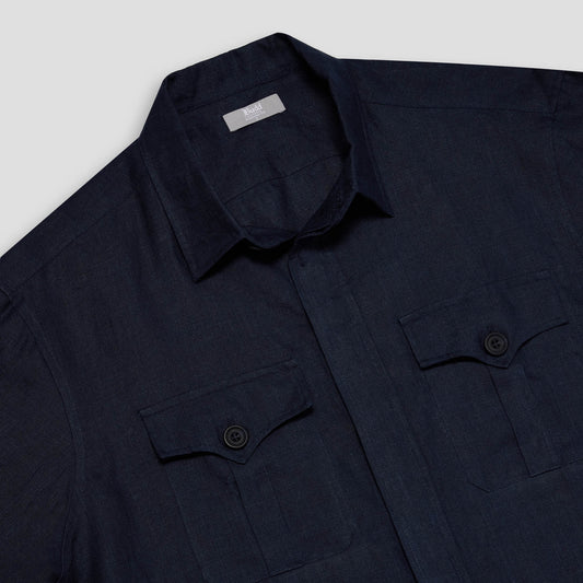 Dark blue shirt with button details on a light gray background