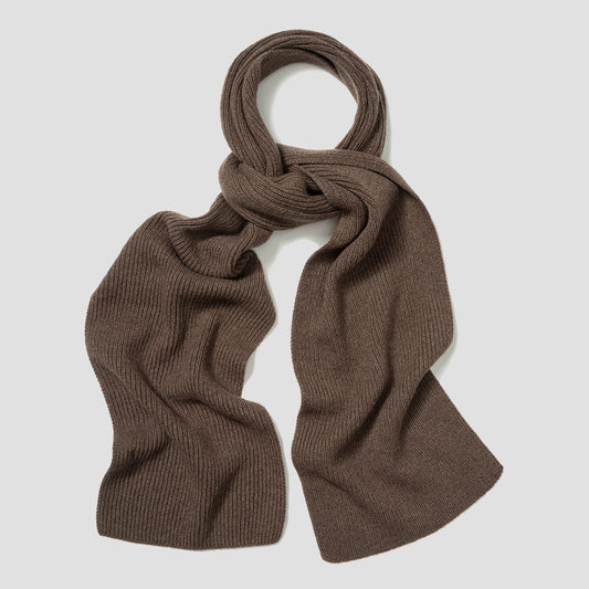 A ribbed knit scarf in a warm brown color, styled in a loose knot and draped against a light gray background.