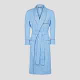 Blue dressing gown with red piping on plain grey background