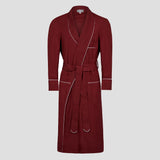 A long burgundy bathrobe with white piping details, shown on a neutral light gray background.