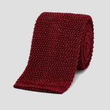 Luxurious wine-colored fine knitted silk tie with a textured square-end design, perfect for sophisticated formal wear.