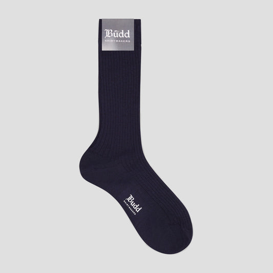 A single dark navy ribbed crew sock with white 'Budd' branding, shown against a solid light gray background.