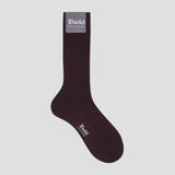 A single dark plum ribbed crew sock with a gray brand label at the cuff and white 'Budd' text on the foot, shown against a light gray background.