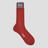 A single ribbed crew sock in a deep rust red color, shown against a light gray background. The sock features a gray brand tag at the cuff with 'Budd Shirtmakers' printed on it, and the brand name 'Budd' is also printed in white on the side of the sock.