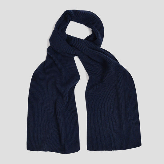 Navy blue knitted scarf on a pale grey background