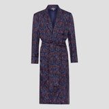 A long-sleeved wrap robe with a matching waist belt, featuring an intricate paisley pattern in navy blue, rust red, and white, displayed on a neutral light gray background.