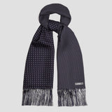 A dark navy blue scarf with a white polka dot pattern and fringed ends, displayed against a light gray background.