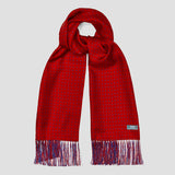A red scarf with a small repeating geometric pattern and fringed ends, shown on a light gray background. A small woven label near one end reads Polo.