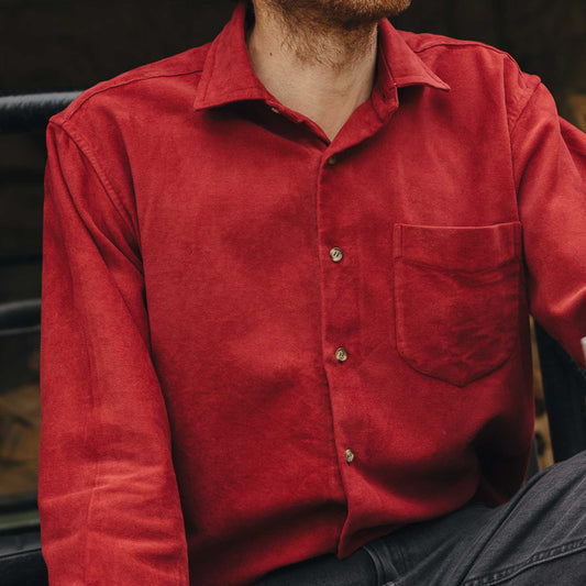 Red shirt worn by a person with a blurred background