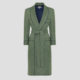 A green textured wool coat with a matching waist tie belt and dark navy piping details, shown on a neutral light gray background.
