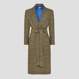 A long plaid wrap dressing gown with a tie belt, featuring a brown, beige, and black check pattern with a bright blue lining visible inside the collar, shown on a neutral gray background.