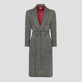 A gray herringbone patterned dressing gown with a matching waist tie belt, featuring red piping details and a vibrant red lining visible inside the collar, shown against a solid light gray background.