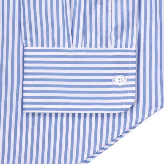 Close-up of a blue and white striped shirt cuff with a single white button, showing the fabric texture and stripe pattern.
