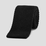 Luxurious black knitted tie crafted from soft, premium pure cashmere with a sophisticated textured weave.