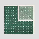 Bottle green silk twill pocket square with ivory polka dots and a refined contrast ivory border.