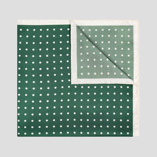 Bottle green silk twill pocket square with ivory polka dots and a refined contrast ivory border.