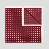 Burgundy silk twill pocket square with ivory polka dots and a refined contrast ivory border.
