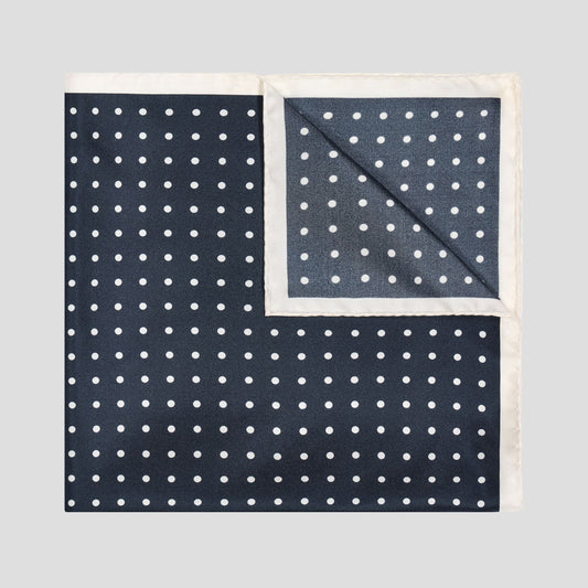 Navy and ivory polka dot silk twill pocket square with an elegant contrast border, screen printed in England.