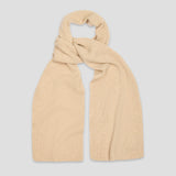 A light beige ribbed knit scarf, styled in a loose knot, displayed against a solid light gray background.