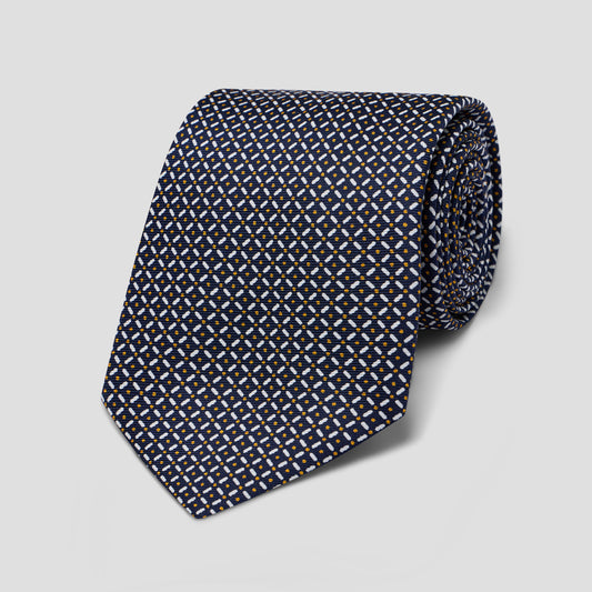 Hand-made navy silk tie featuring a geometric trellis and dot pattern, 8.5cm blade width, crafted in England.