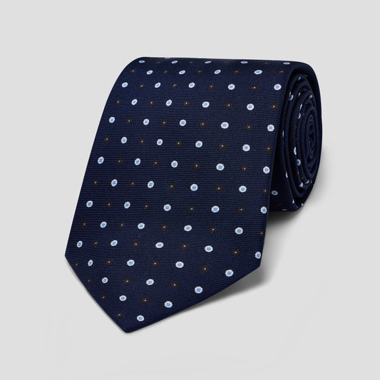 Navy silk tie featuring a refined blue and white double-dot motif, hand-made in England with a classic 8.5cm blade width.