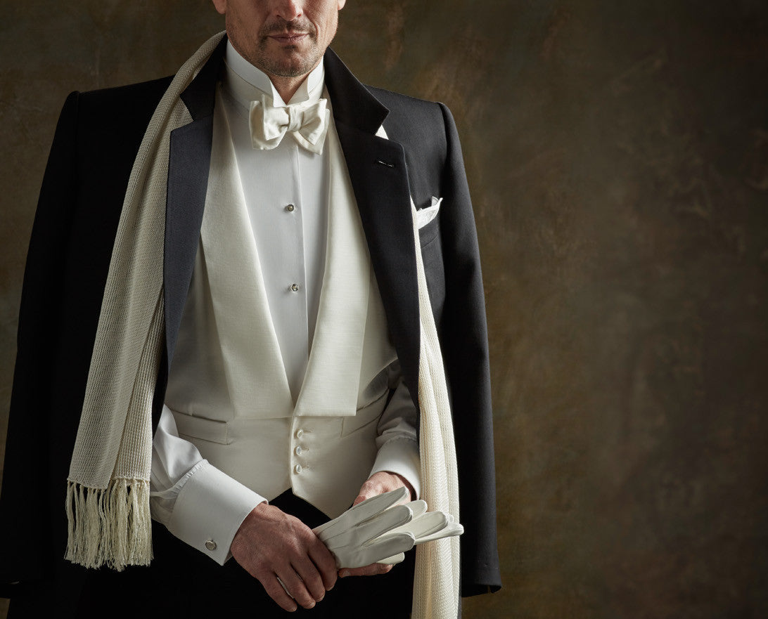 White Tie Attire Model wearing white dress shirt with wing collar, white dress scarf and white bow tie for Budd with dress gloves