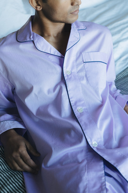 Close up of man in wearing Lilac pyjamas on bed