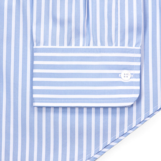Close-up of a light blue and white striped shirt showing the front placket and a buttoned cuff pocket.
