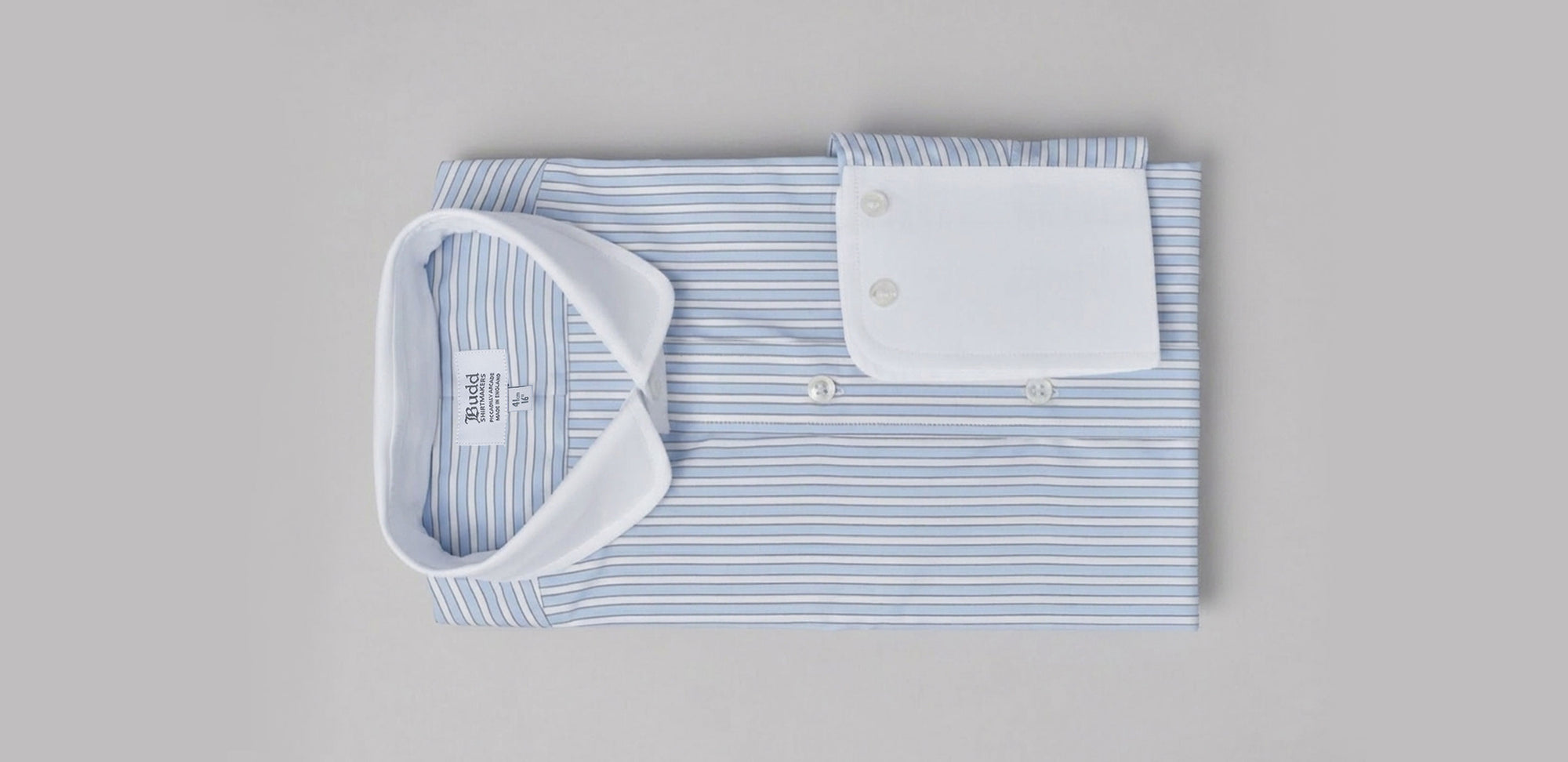 Stripe blue shirt with white collar and cuffs on plain background
