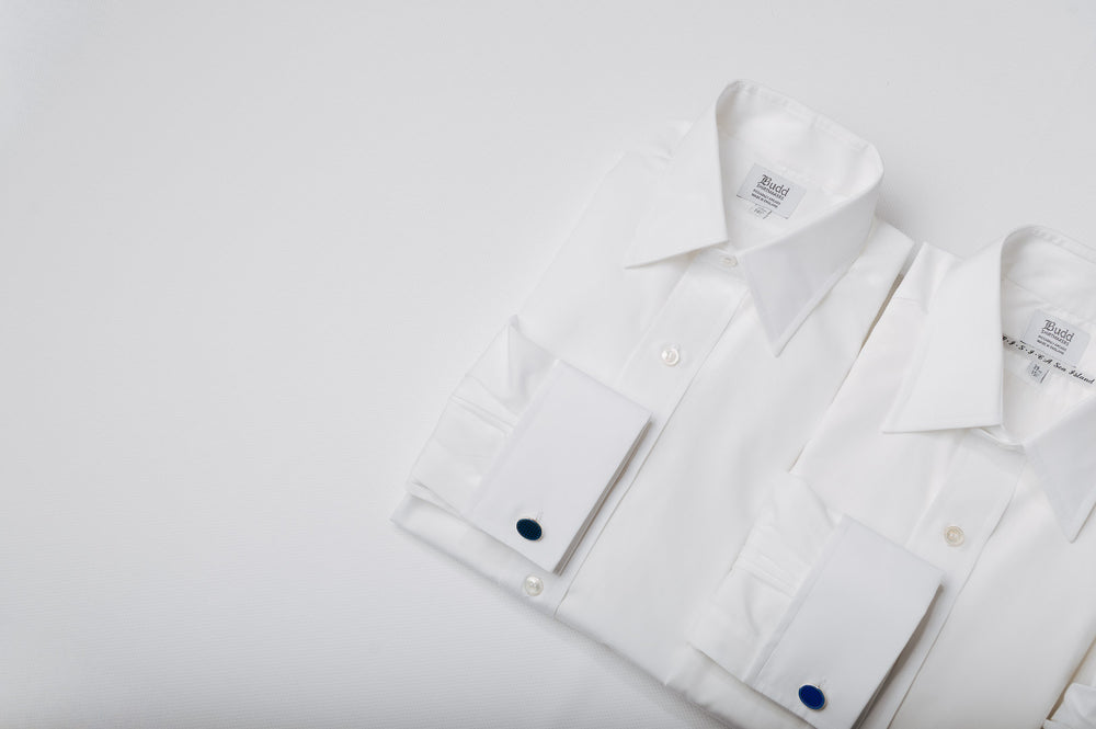 White shirts with brand labels on a light gray background