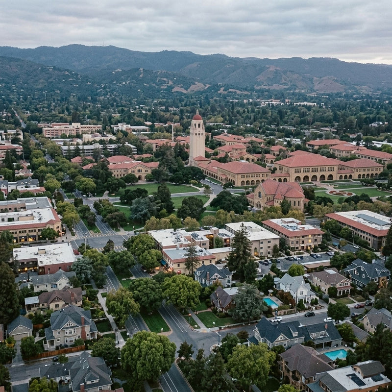 Palo Alto Aerial view of a university campus with red-roofed buildings and surrounding residential area.