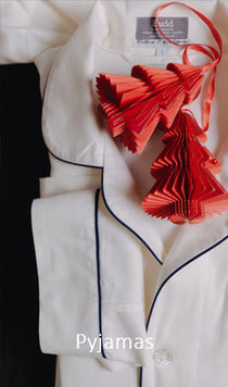 White pajamas with red tassels and a tag on a black background